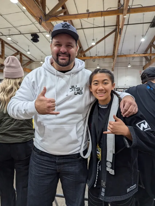 Oregon Jiu Jitsu Lab coach with student at competition