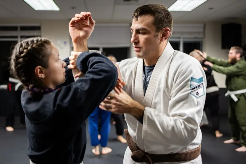 Brown belt training with young student at Oregon Jiu Jitsu Lab